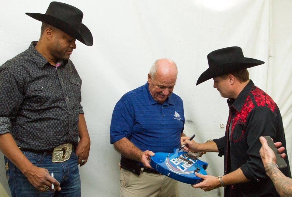 mayor rusty big and rich signing guitar